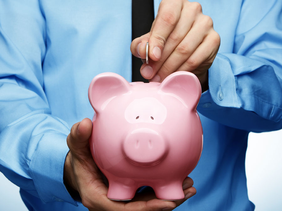 businessman saving money on piggybank