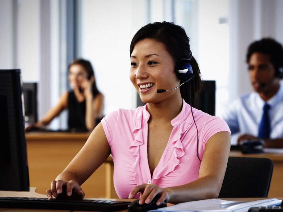 cheerful customer support agent working in call center