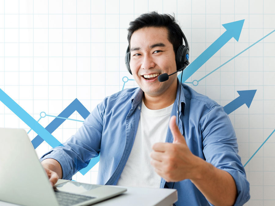 Japanese call center agent giving thumbs up with successful chart background