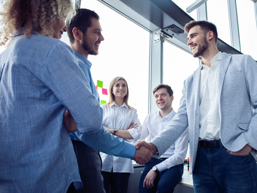 german call center exective shaking hands on business deal with company in meeting
