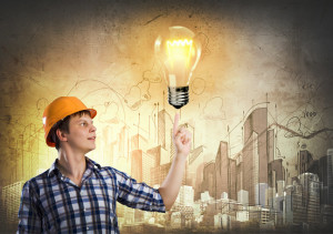 worker-pointing-to-bulb-with-building-background