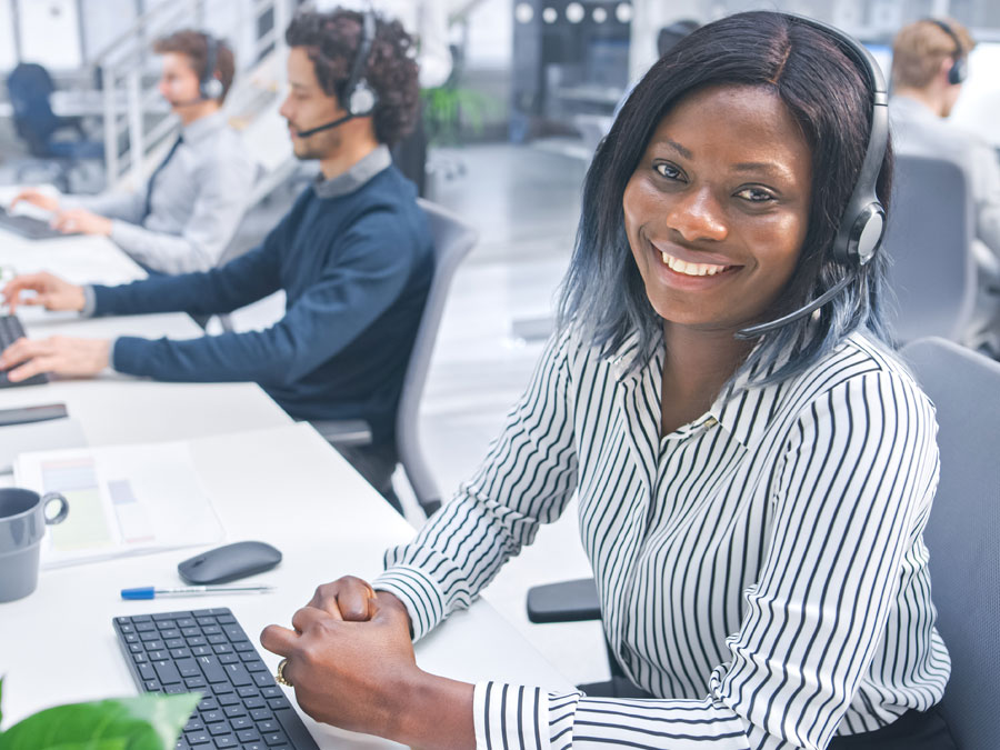 smiling customer support agent working in call center