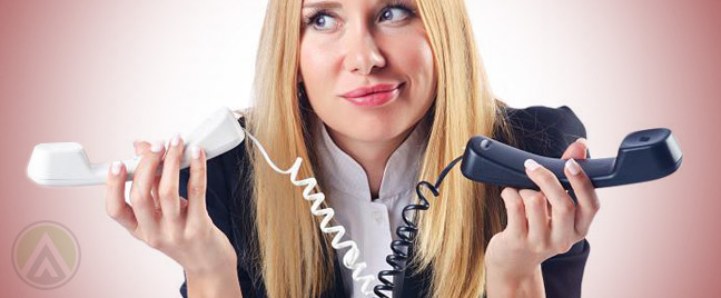 female-call-center-agent-holding-two-phones