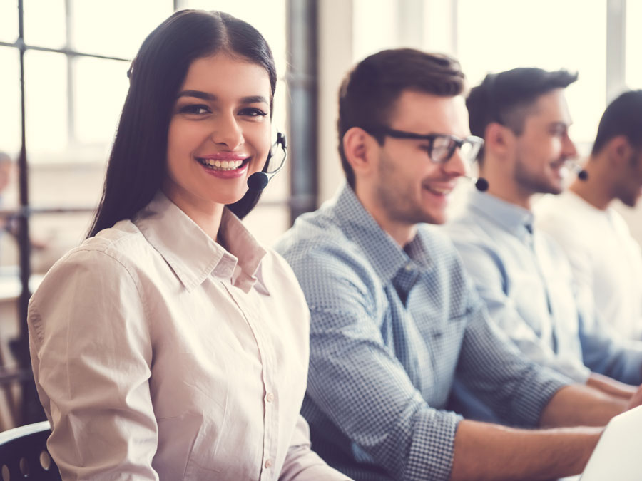 young multilingual call center customer service agents smiling at work