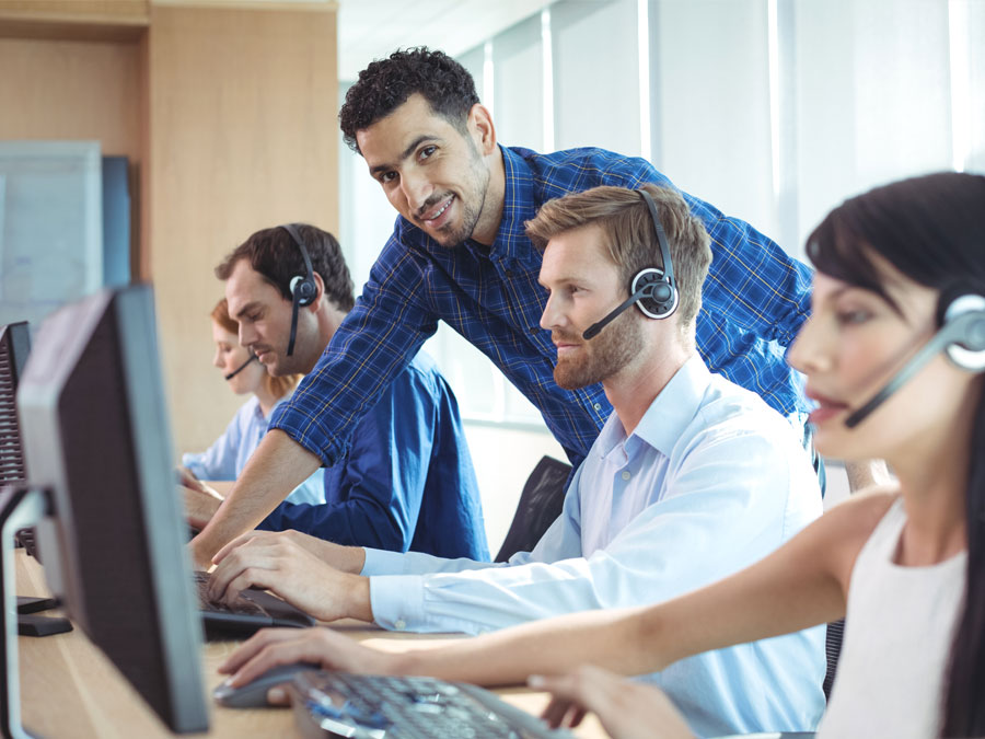 call center team leader helping customer support agent