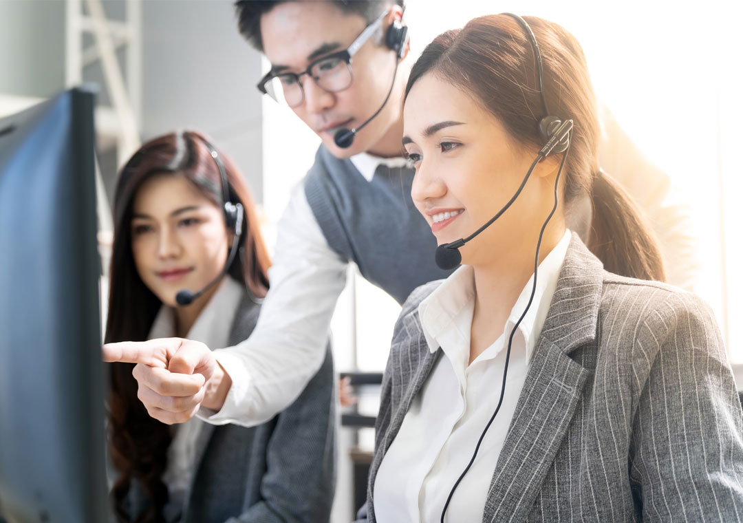 team leader listening to customer service call center calls for quality assurance