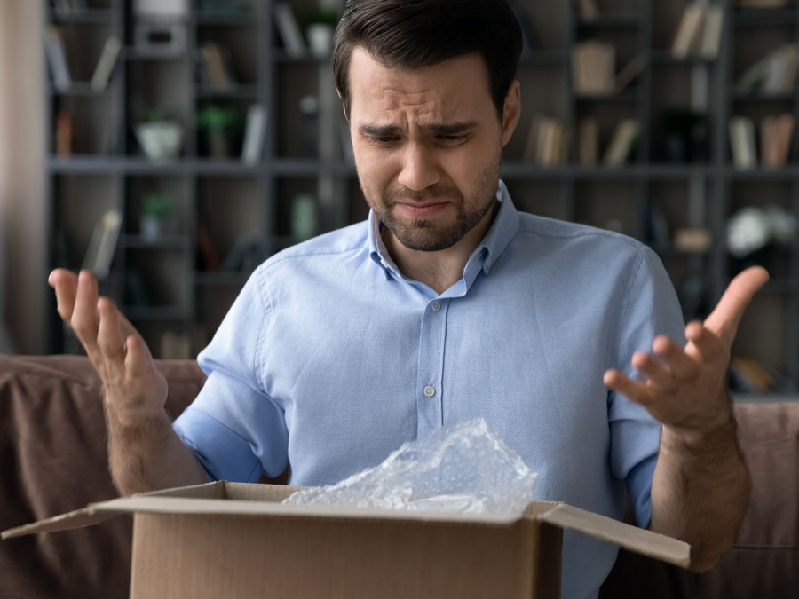 customer service on social media disappointed distraught dissatisfied man opening box package delivery