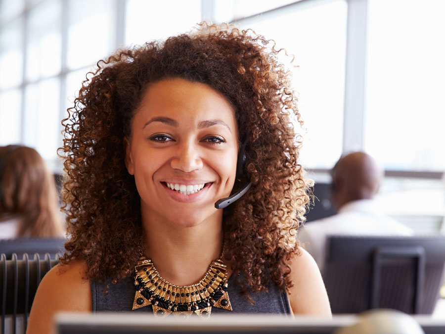 smiling customer service agent in call center