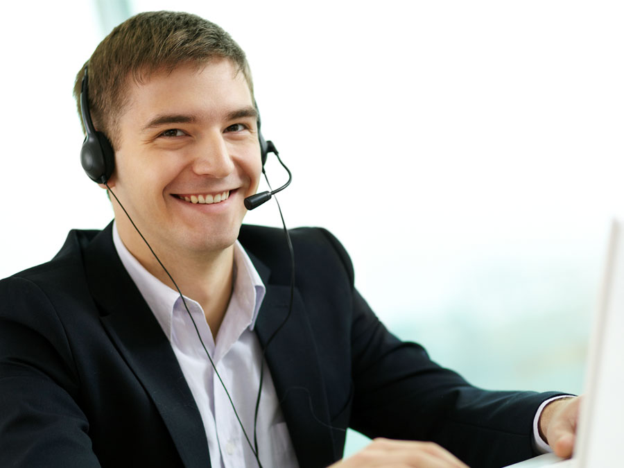 smiling live chat support agent at call center