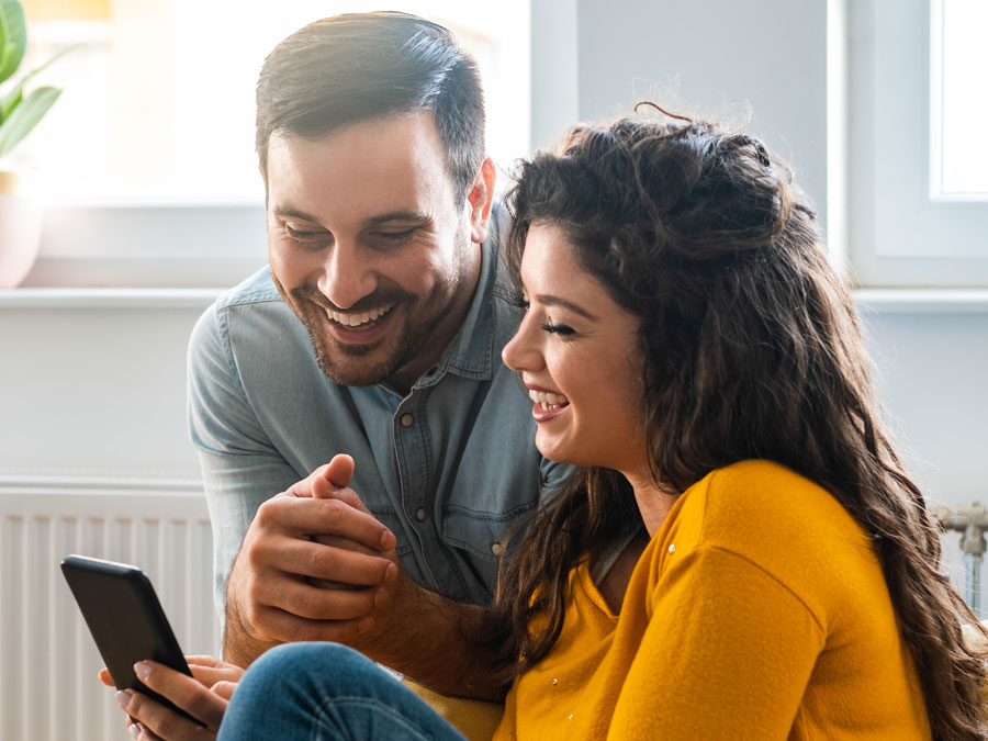 call quality monitoring depiction delightful customers couple looking at smartphone after contact center call