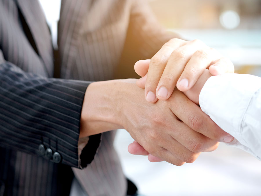 caring businessman comforting customer hand