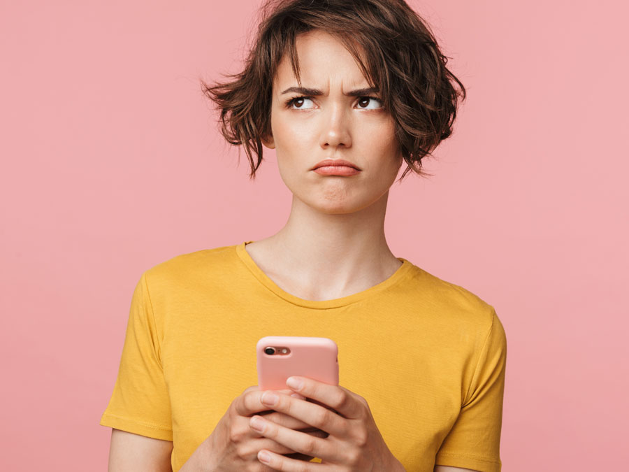 confused woman holding phone