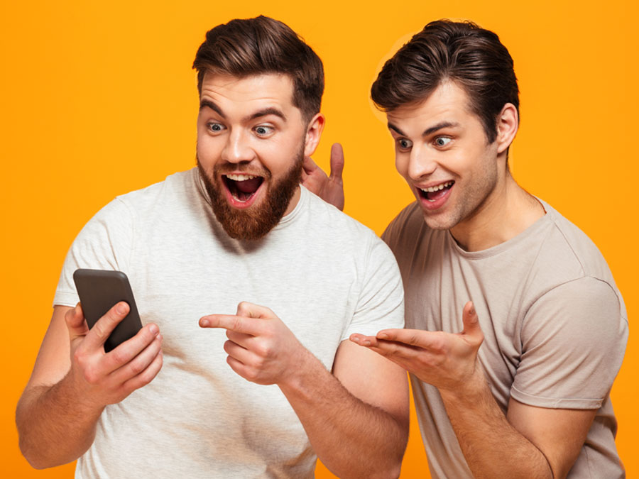 impressed delighted customers pointing at smartphone