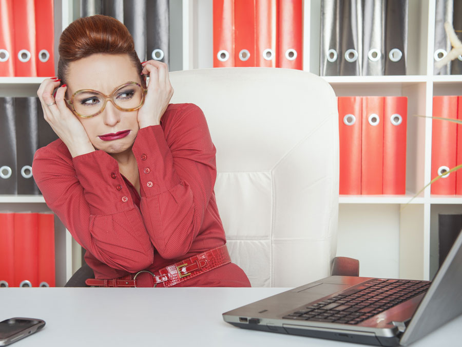 business executive in red scared of laptop