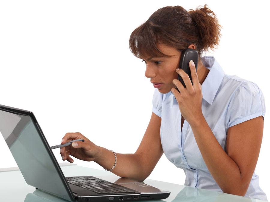 Consumer on a call with customer service team looking at laptop