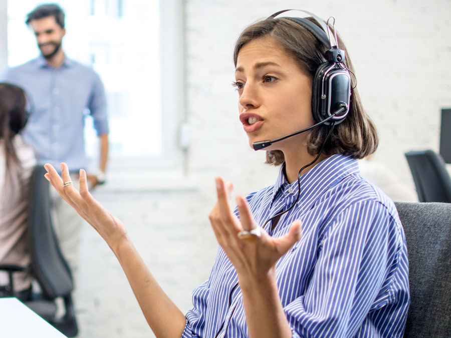 customer service agent busy talking to customer in call center with hand gestures