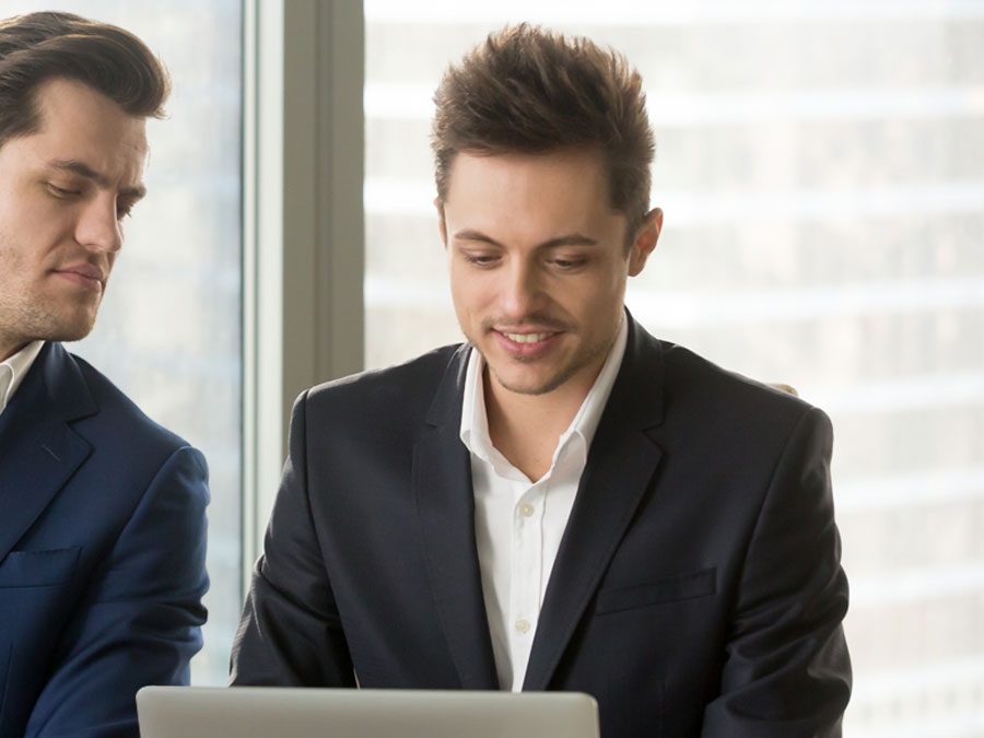 social engineering techniques Shoulder Surfing Dumpster Diving nosy employee looking at laptop over coworker shoulder