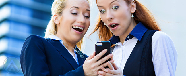 two-women-amused-by-something-on-smartphone
