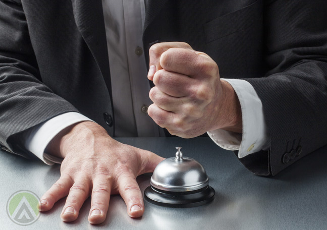 disgruntled-male-customer-hitting-bell-with-fist