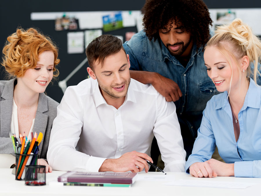 multilingual call center team reading notes with customer support team leader