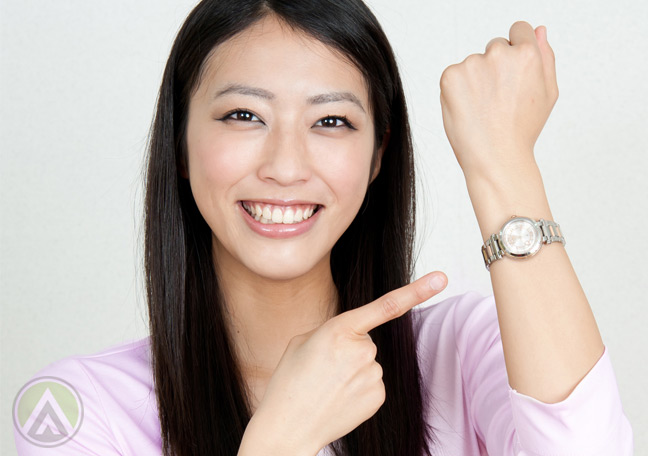 smiling-Asian-woman-pointing-to-watch