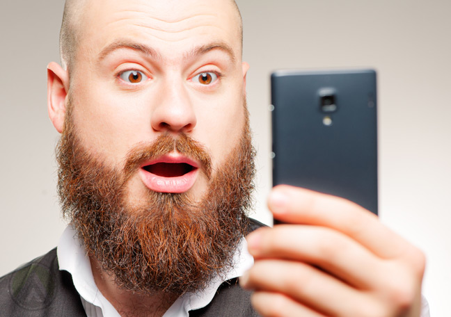 bearded-man-surprised-at-smartphone