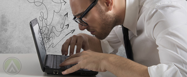 businessman-in-glasses-working-on-laptop-netbook-computer-looking-closely