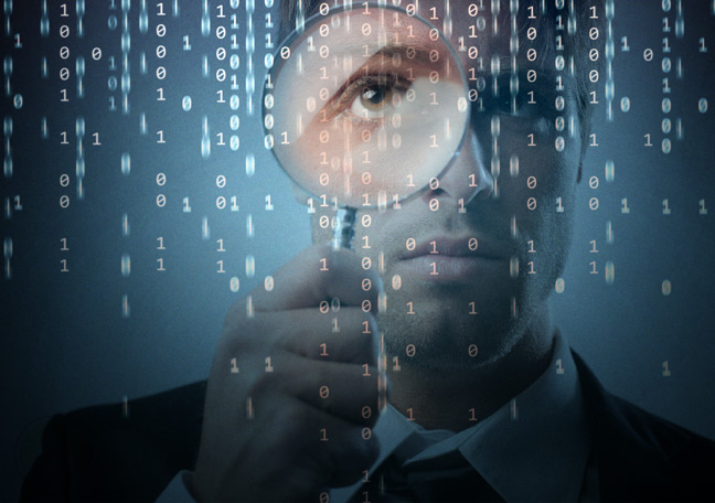 businessman-with-magnifying-lense-looking-at-computer-codes-and-text