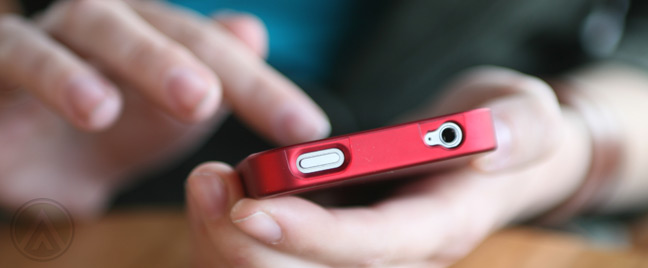 close-up-of-hand-using-red-smartphone