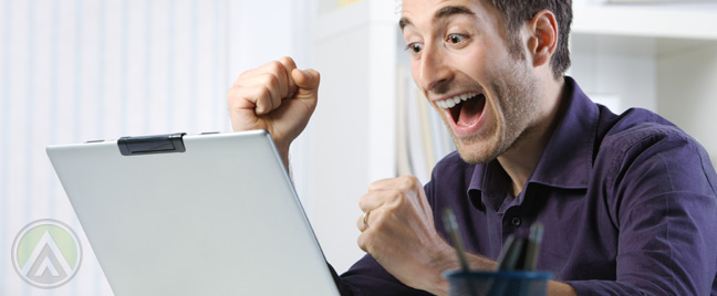 excited-businessman-in-purple-shirt-with-laptop