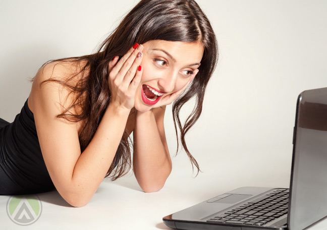 woman-shocked-and-delighted-at-laptop