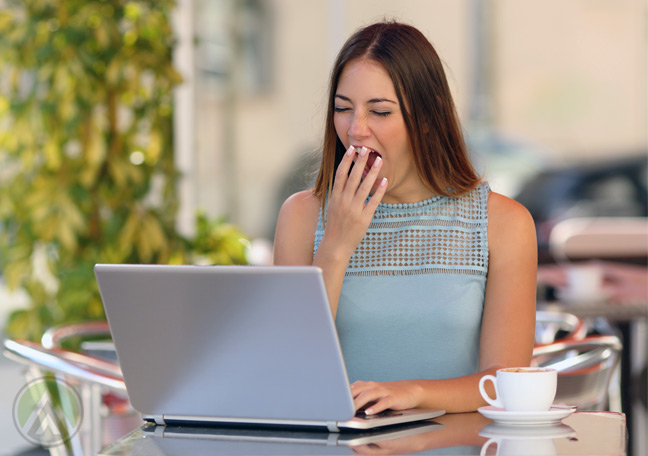 bored-woman-reading-laptop-yawning