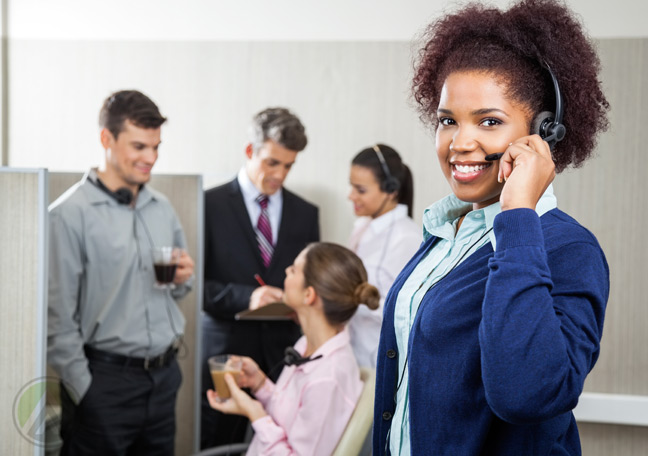 female-african-american-call-center-agent-with-customer-service-coworkers-in-the-back