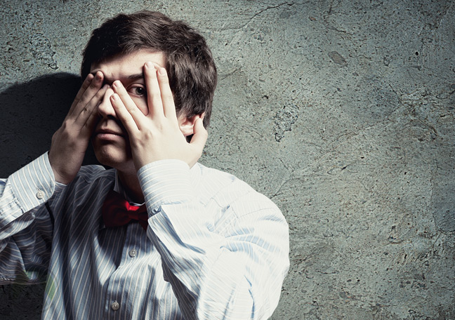 young-man-in-bowtie-covering-eyes