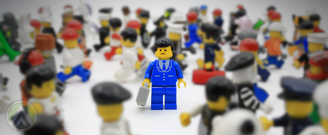 Lego-minifigures-busy-blurred-sad-ignored-figure-in-blue-business-suit-in-the-middle