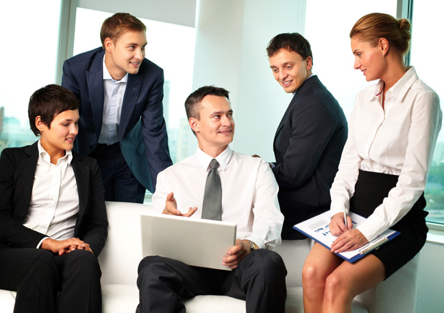 business-team-in-discussion-with-boss-with-laptop