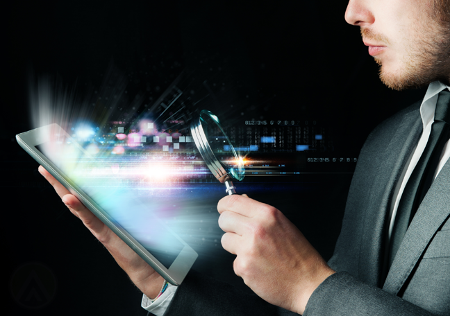 businessman-looking-at-tablet-through-magnifying-glass-in-the-dark