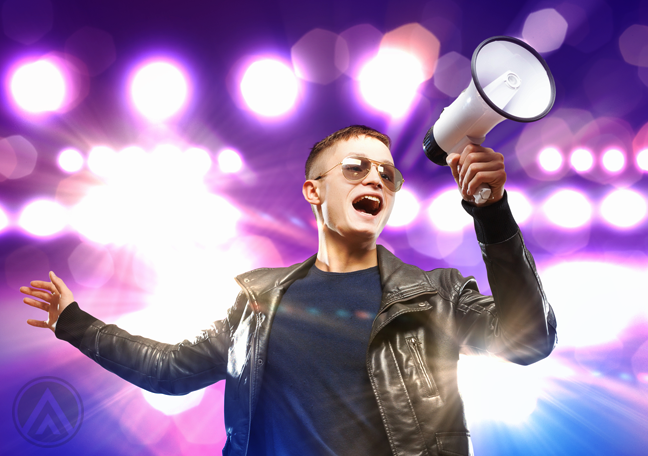 man-in-leather-jacket-and-glasses-shouting-on-megaphone-with-bright-purple-backdrop