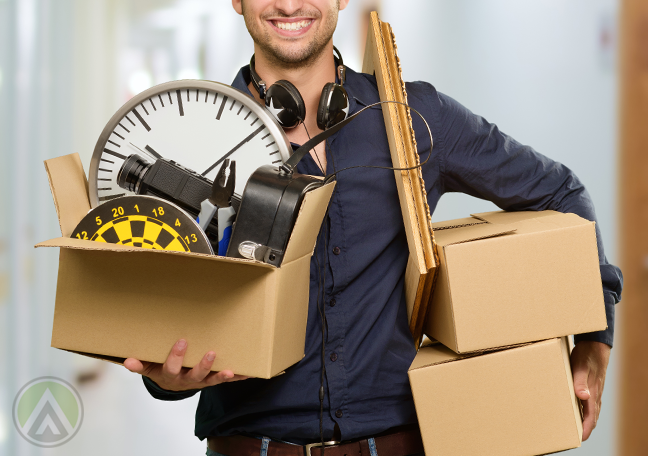 man-wearing-headphones-carrying-computer-parts-boxes