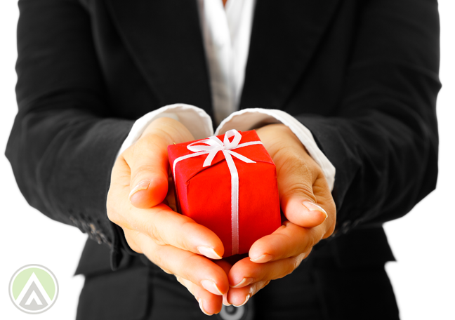 female-employee-holding-out-hand-with-red-gift-box