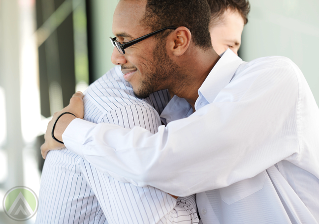 diverse businessmen-hugging