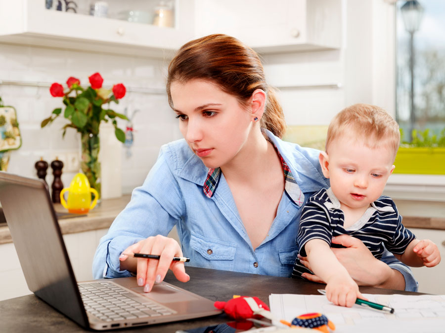 outsourcing live chat support agent at home taking care of baby in kitchen