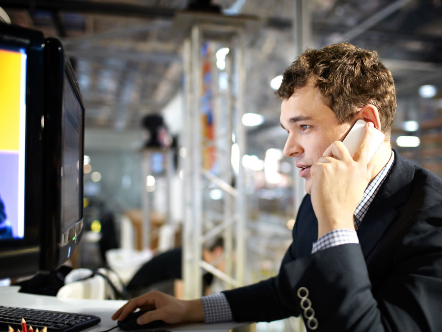 tech support agent on the phone using computer giving IT helpdesk