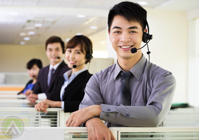 asian-filipino-call-center-agents-smiling-by-office-cubicles