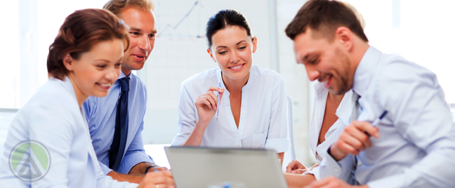 business-team-smiling-at-presentation-on-laptop