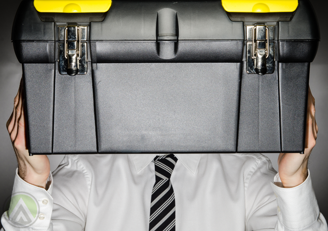 businessman-employee-carrying-tool-box-in-front-of-head