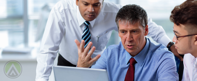 matured-businessmen-discussing-business-in-front-laptop