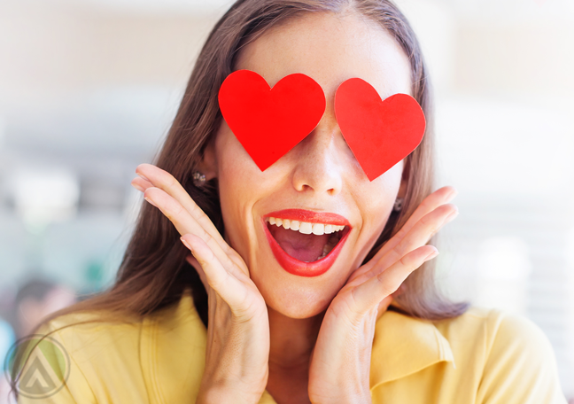 delighted-woman-in-yellow-with-hearts-for-eyes