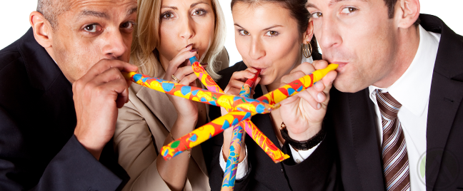 diverse-team-celebrating-holiday-blowing-colorful-party-kazoos