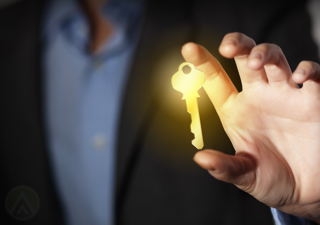 businessman-in-the-dark-holding-glowing-key